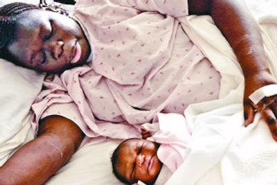 
Nyarot Bangout rests Tuesday with her newborn daughter, Nyawarga, at Deaconess Medical Center in Spokane.  
 (Brian Plonka / The Spokesman-Review)