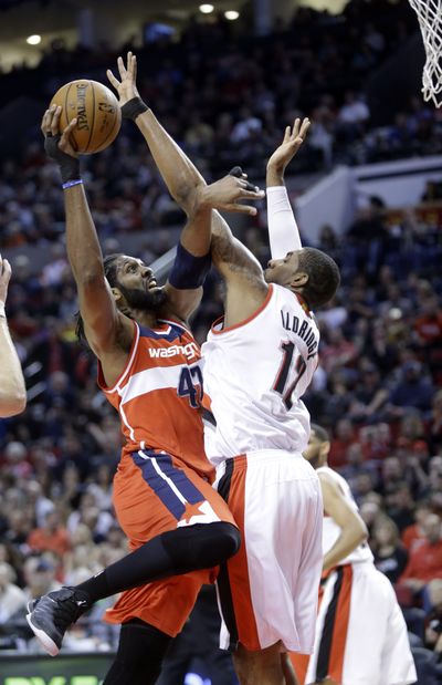 Portland’s LaMarcus Aldridge, right returned to the Blazers’ lineup and scored a game-high 26 points in the Blazers’ win. (Associated Press)