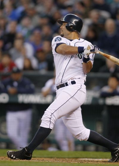 Mariners’ Jesus Montero hits a two-RBI double against the Athletics in the sixth Saturday. (Associated Press)