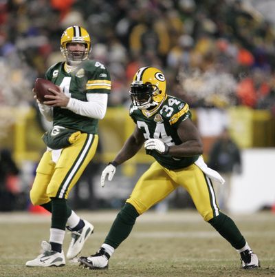 This Jan. 20, 2008 photo shows Green Bay Packers quarterback Brett Favre (4) dropping back to pass with Vernand Morency (34) blocking during the NFC Championship football game in Green Bay, Wis. (Mike Roemer / Associated Press)