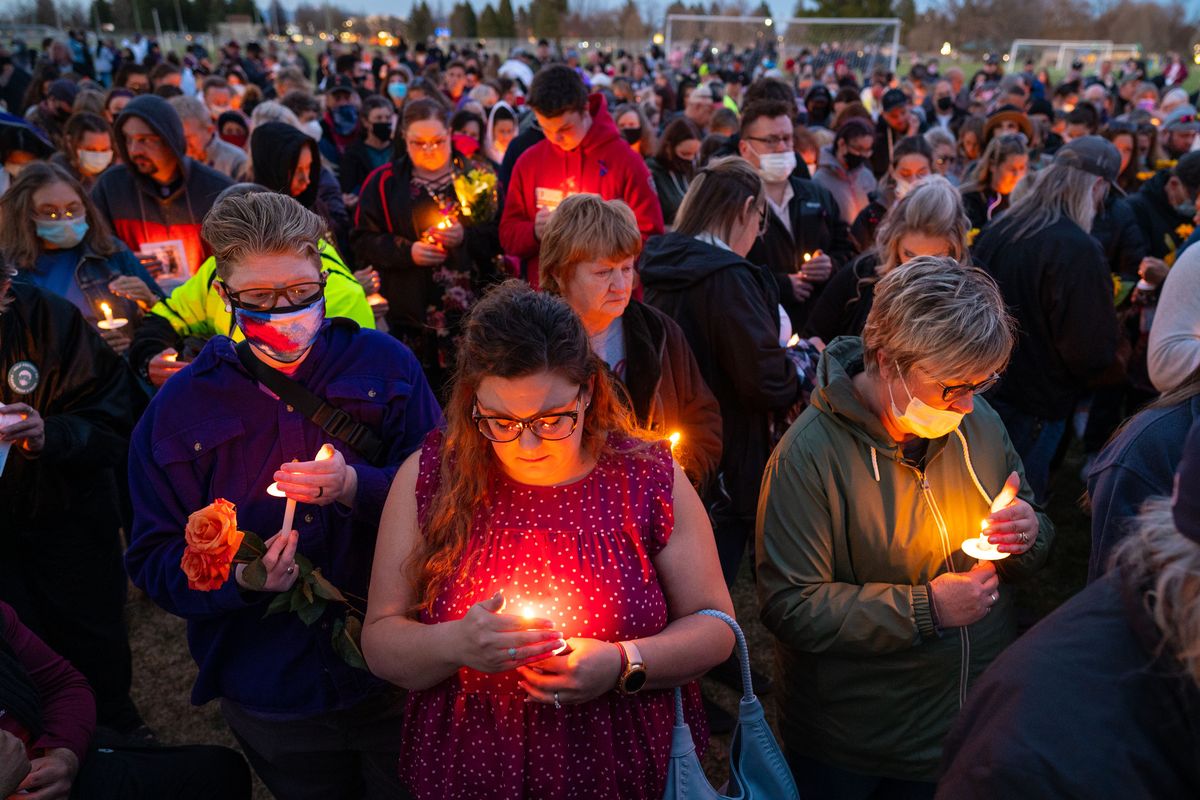 In Franklin Park on Wednesday night, hundreds of family members, friends and co-workers attend a candlelight vigil for Kassie Dewey, who was killed in an assault Sunday.  (COLIN MULVANY/THE SPOKESMAN-REVIEW)