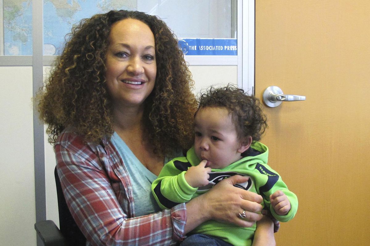 In this March 20, 2017 photo, Rachel Dolezal poses for a photo with her son, Langston in the bureau of the Associated Press in Spokane, Wash. The former NAACP leader, who was born to white parents but posed for years as a black woman, is facing charges of welfare fraud. (Nicholas K. Geranios / AP)