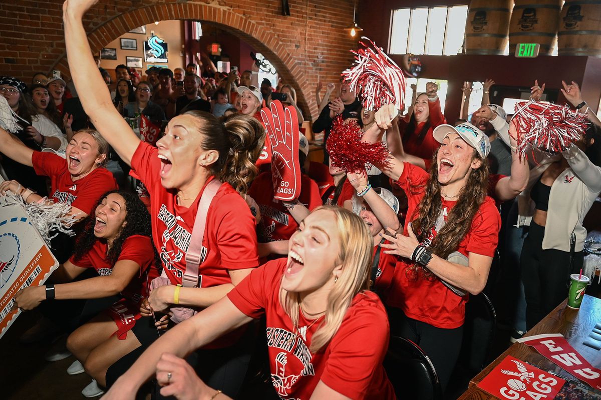 Eastern women’s basketball players Jamie Loera, left center, Milly Knowles and Gabrielle Jung explode from their seats at Barrelhouse Pub and Pizza in Cheney Sunday.  (DAN PELLE/THE SPOKESMAN-REVIEW)