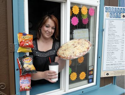 Rachelle Latapie offers take-and-bake pizzas,  deli sandwiches and coffee drinks  at Grounds and Grub. (J. BART RAYNIAK / The Spokesman-Review)