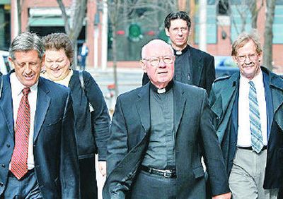 
Bishop William Skylstad, center, is flanked by attorneys and clergy members as he heads  to U.S. Bankruptcy Court in downtown Spokane on Tuesday. 