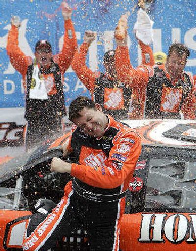 
Tony Stewart is sprayed by teammates as he celebrates after winning the NASCAR Sirius Satellite Radio at the Glen.
 (Associated Press / The Spokesman-Review)