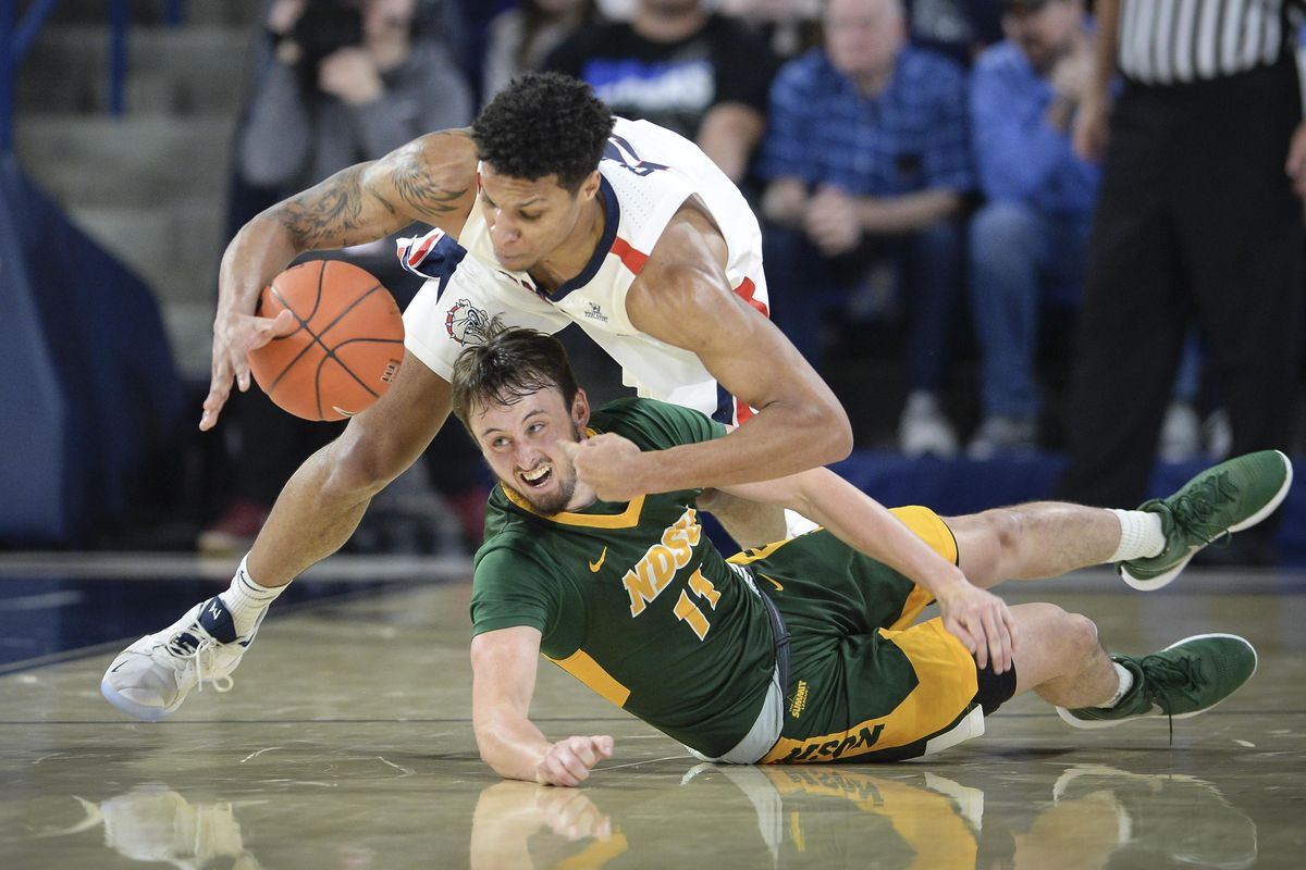 Gonzaga forward Brandon Clarke battles North Dakota State guard Jared Samuelson for a loose ball, Nov. 26, 2018, in the McCarthey Athletic Center. (Dan Pelle / The Spokesman-Review)