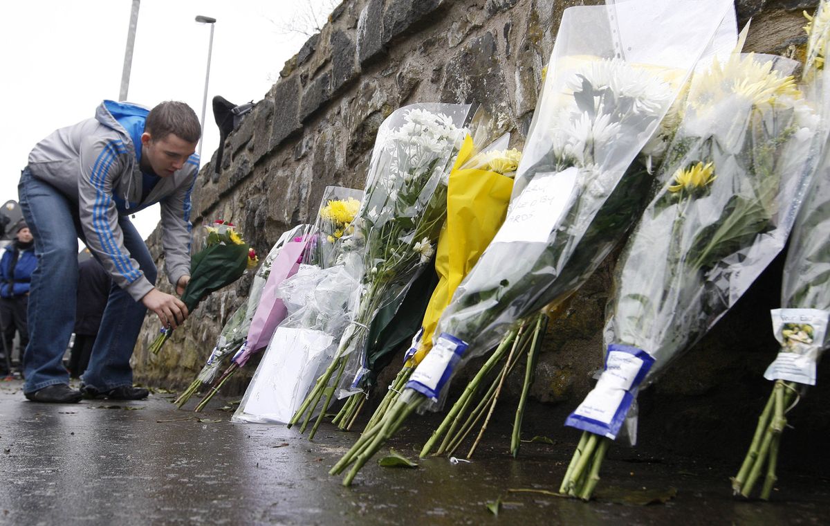 A man leaves flowers near Massereene army barracks, in Antrim,  Northern Ireland, on Sunday.  (Associated Press / The Spokesman-Review)