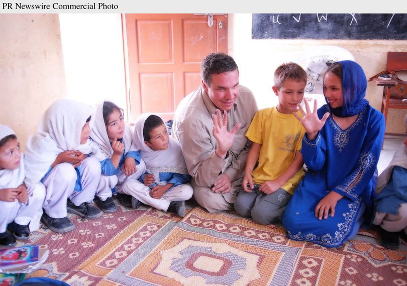 Greg Mortenson, his son Khyber, and daughter, Amira Mortenson, with students at Gultori War refugee school, Bromolo Colony, Karakoram mountains. These students escaped massive Indian artillery bombardment during the 1999 Kargil crisis on the Pakistan - India border. Photo: Deirdre Eitel 2008.  (Associated Press)