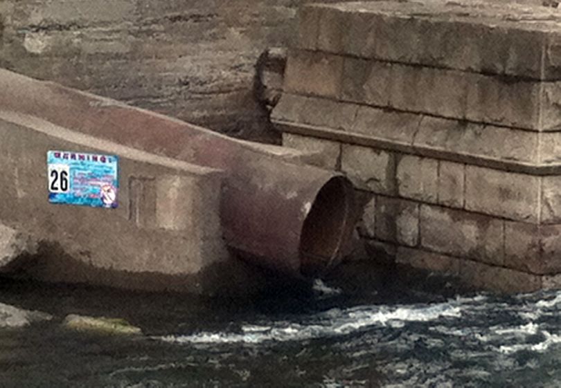 Untreated sewage and storm water flow into the Spokane River under the Monroe Street Bridge on Dec. 15. The city has about 30 pipes that release sewage into the river during rain or snowmelt.  (Jonathan Brunt)