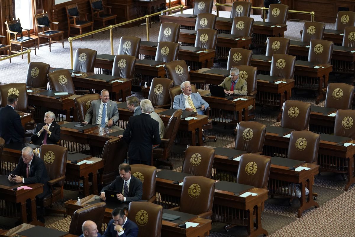In this July 13, 2021 photo, empty seats are seen in the House Chamber at the Texas Capitol in Austin, Texas. Texas Democrats left the state to block sweeping new election laws, while Republican Gov. Greg Abbott threatened them with arrest the moment they return.  (Eric Gay)