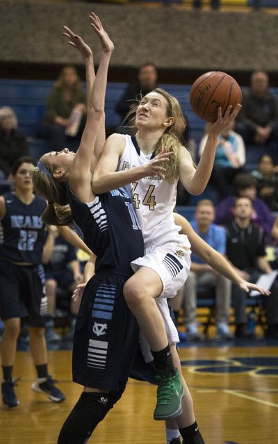 Mead’s Sue Winger heads to the basket as Central Valley's Lexie Hull defends in the first half. (Colin Mulvany)