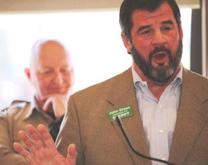 With Sheriff Ben Wolfinger in the background, challenger John Green speaks at the Panhandle Pachyderm Club in Post Falls. The event took place recently.