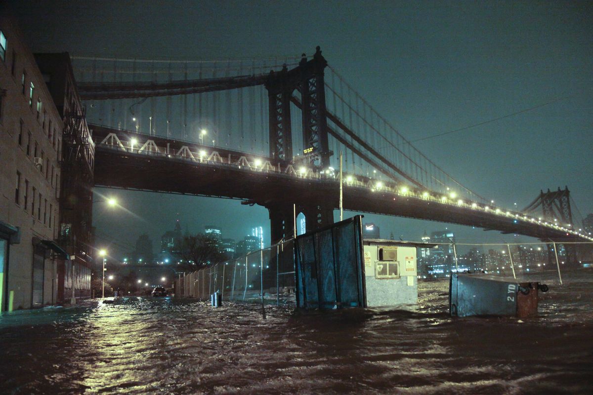 Streets are flooded under the Manhattan Bridge in the Dumbo section of Brooklyn, N.Y., Monday, Oct. 29, 2012. Sandy continued on its path Monday, as the storm forced the shutdown of mass transit, schools and financial markets, sending coastal residents fleeing, and threatening a dangerous mix of high winds and soaking rain. (Bebeto Matthews / Associated Press)
