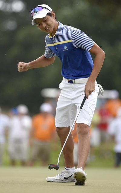 Australia's Min Woo Lee reacts as he sinks a putt on the 34th hole on the final day of the U.S. Junior Amateur golf tournament in Ooltewah, Tenn., on Saturday, July 23, 2016. (Associated Press)