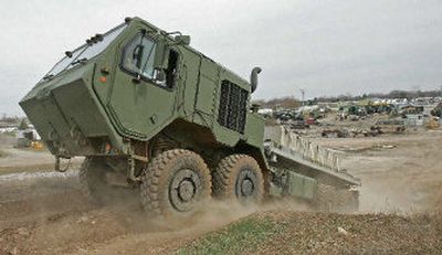 
Oshkosh Truck executive Gary Schmiedel drives their diesel hybrid truck up a hill in Oshkosh, Wis. 
 (Associated Press / The Spokesman-Review)