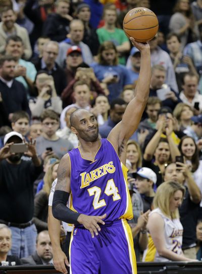 Kobe Bryant acknowledges crowd after hitting milestone. (Associated Press)