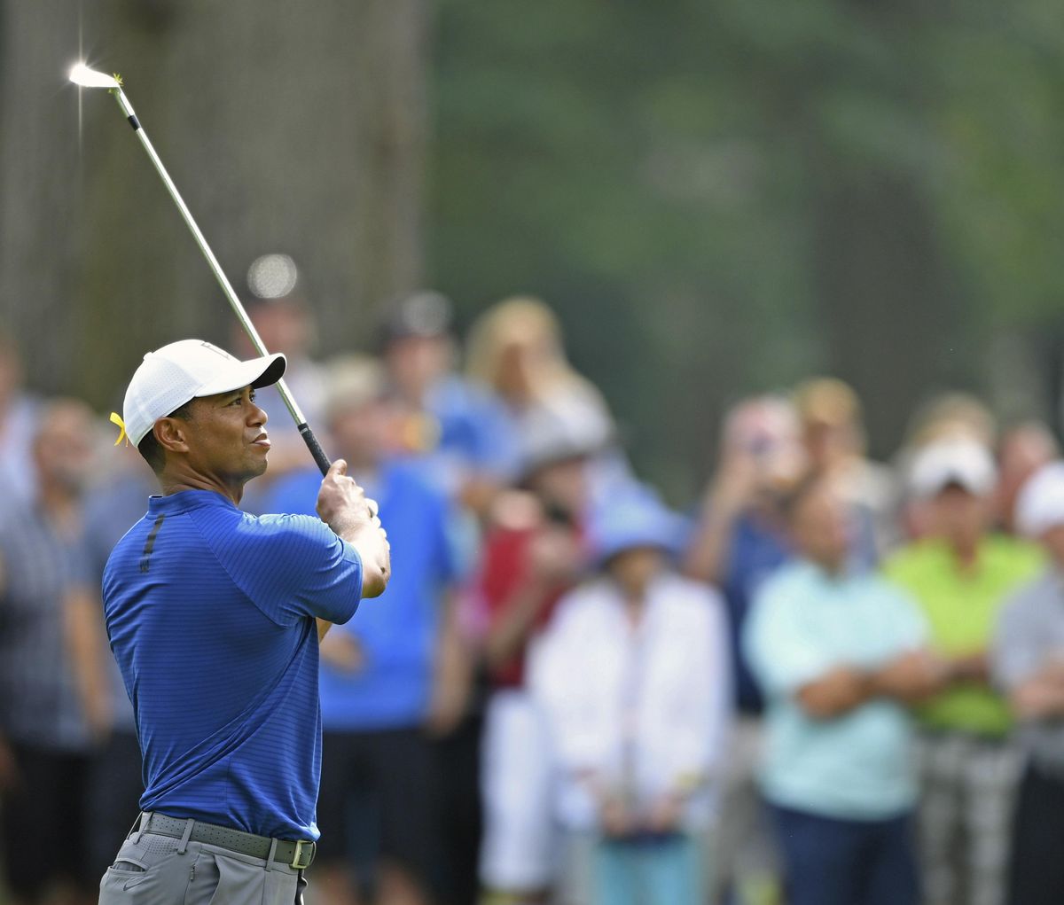 Tiger Woods follows through on his approach shot on the 10th hole during the first round of the Bridgestone Invitational golf tournament at Firestone Country Club, Thursday, Aug. 2, 2018, in Akron, Ohio. (David Dermer / Associated Press)