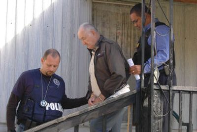 
Deputy U.S. Marshal Richie Bradley, left, leads fugitive Willard Greene along with Cocke County Sheriff's Department Detective Derrick Woods during  a roundup  Monday in Sevierville, Tenn. 
 (Associated Press / The Spokesman-Review)