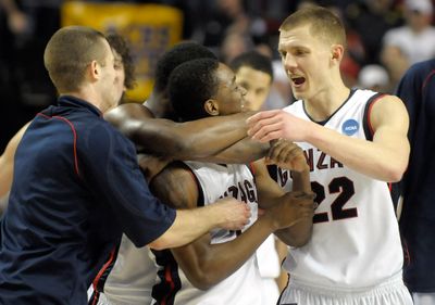 Gonzaga’s Demetri Goodson is swarmed by teammates after hitting the winning shot Saturday to beat Western Kentucky. (Christopher Anderson / The Spokesman-Review)