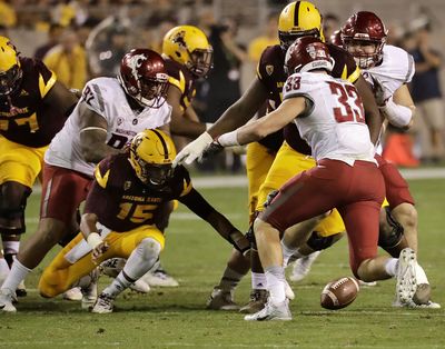 Arizona State quarterback Dillon Sterling-Cole (15) fumbles the football as Washington State defensive lineman Dylan Hanser (33) and nose tackle Robert Barber (92) defend during the second half of an NCAA college football game, Saturday, Oct. 22, 2016, in Tempe, Ariz. (Matt York / AP)