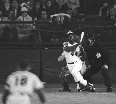 Atlanta Braves' Hank Aaron eyes the flight of the ball after hitting his 715th career homer in a game against the Los Angeles Dodgers in Atlanta in this April 8, 1974  photo. (Harry Harris / Associated Press)