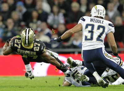 San Diego’s Eric Weddle closes in as New Orleans’ Aaron Stecker is tackled by Matt Wilhelm. (Associated Press / The Spokesman-Review)