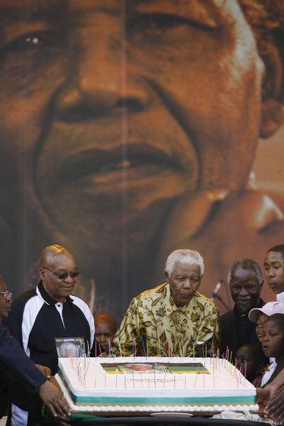 Former South African President Nelson Mandela blows on a birthday cake  in Pretoria, South Africa, Saturday.  (Associated Press / The Spokesman-Review)