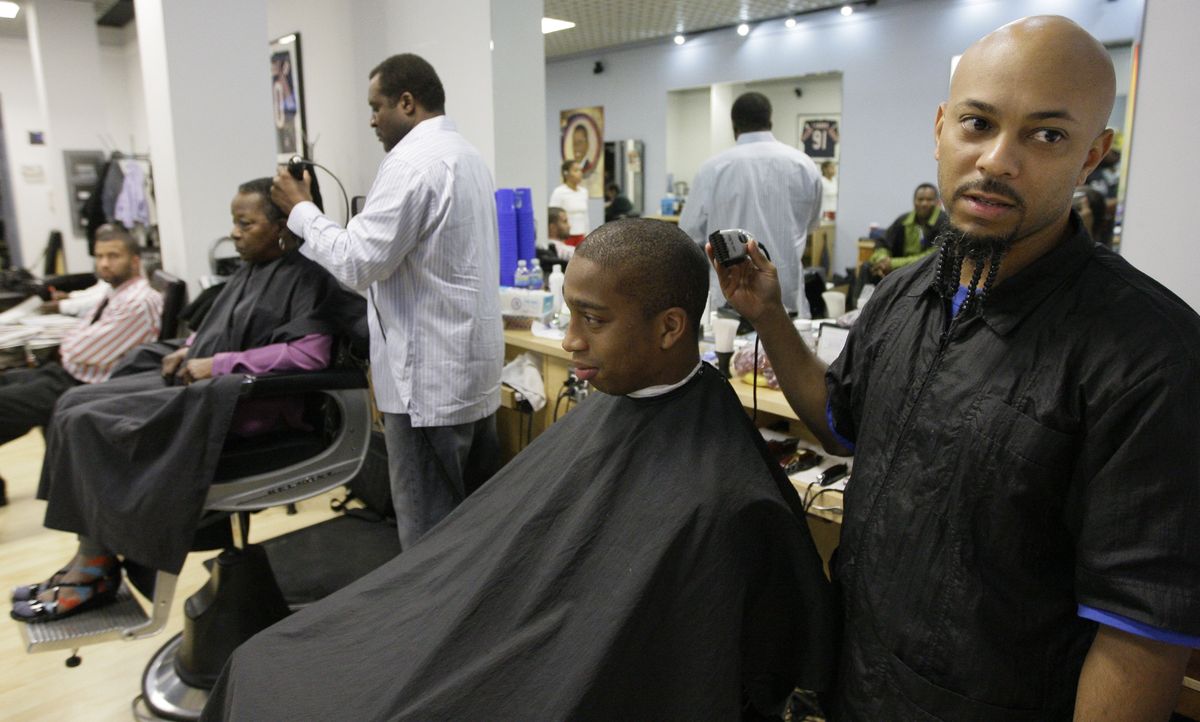 Barber Tony Coye cuts Kenneth Clay’s hair at the Hyde Park Hair Salon  in Chicago. (M. Green / The Spokesman-Review)