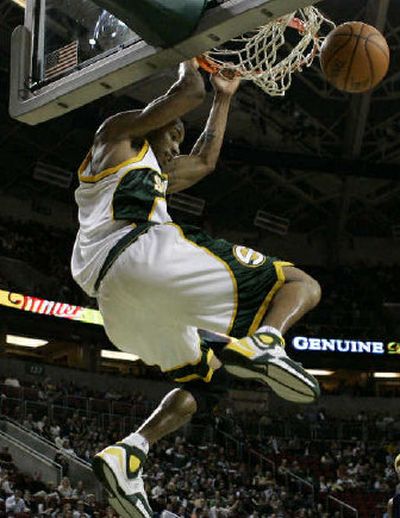 
SuperSonics forward Rashard Lewis enjoys his dunk after stealing the ball. 
 (Associated Press / The Spokesman-Review)