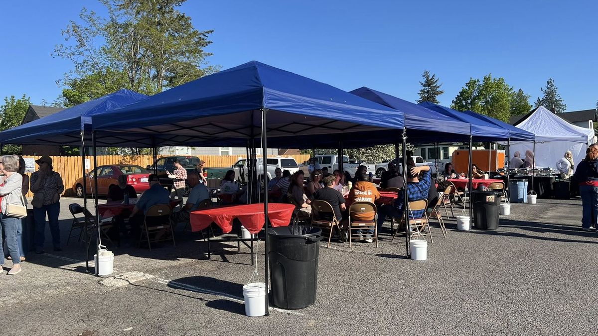 People are seen enjoying food at the Global Food and Art Market in Spokane. The market, 733 W. Garland Ave., is open Tuesdays through July 29. (Courtesy of Rhonda Fischer)