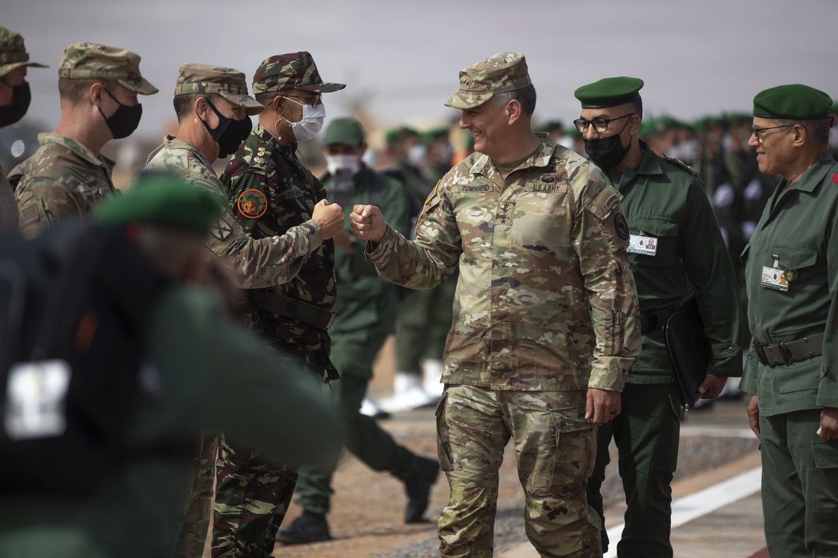 Gen. Stephen J. Townsend, head of the United States Africa Command, center, arrives alongside General Belkhir el-Farouk, Right, Moroccan Southern Zone Commander, to his right, to watch a large scale drill as part of the African Lion military exercise, in Tantan, south of Agadir, Morocco, Friday, June 18, 2021. The U.S.-led African Lion war games, which lasted nearly two weeks, stretched across Morocco, a key U.S, ally, with smaller exercises held in Tunisia and in Senegal, whose troops ultimately moved to Morocco.  (Mosa