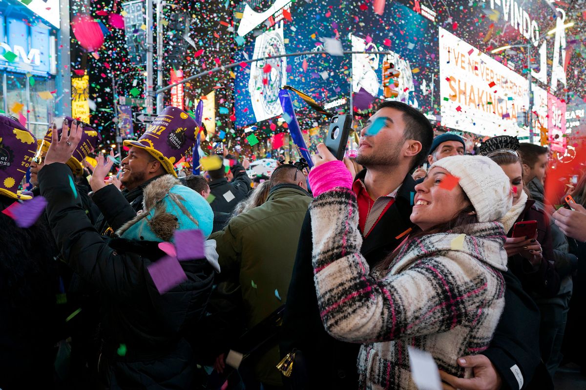 FILE — Confetti falls as people celebrate the new year in New York