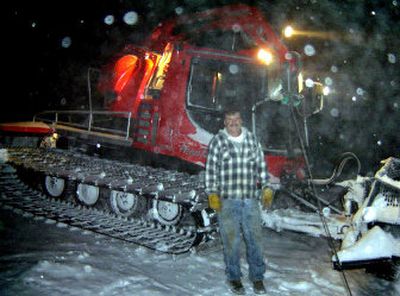
Chris Burmeister stands with his winch-equipped Pisten Bully on a snowy night at Silver Mountain. 
 (Carl Gidlund / The Spokesman-Review)
