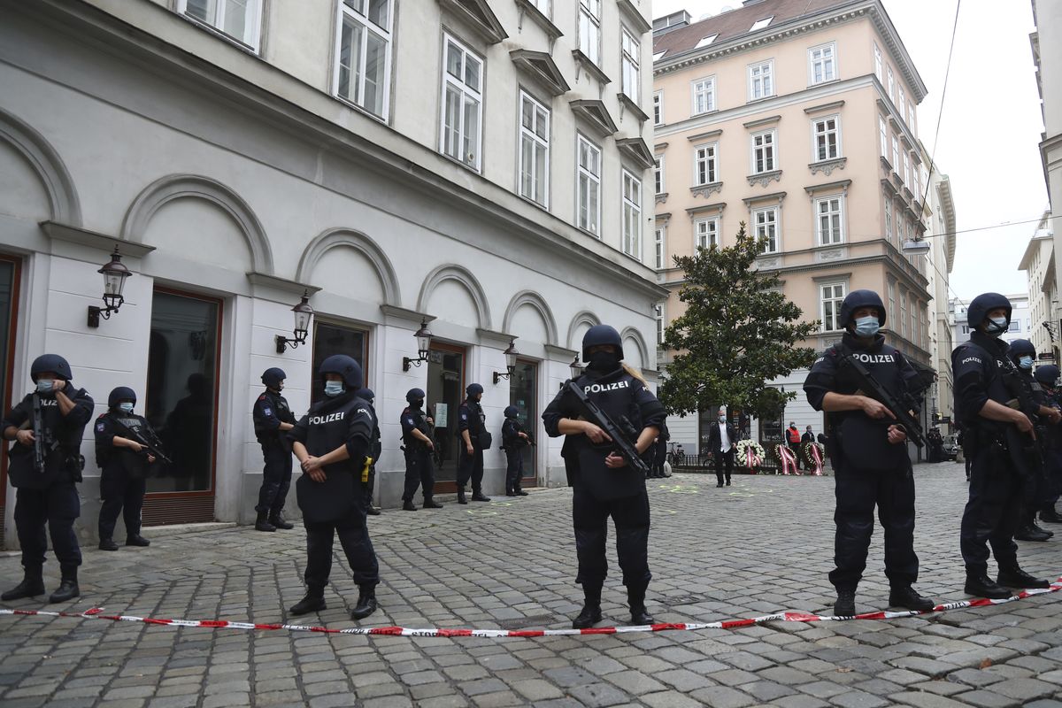 Police officers guard the scene in Vienna, Austria, Tuesday, Nov. 3, 2020. Police in the Austrian capital said several shots were fired shortly after 8 p.m. local time on Monday, Nov. 2, in a lively street in the city center of Vienna. Austria