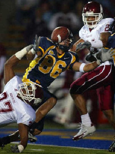 
WSU's Eric Frampton, left, and Alex Teems break up a pass intended for Sam DeSa. 
 (Associated Press / The Spokesman-Review)