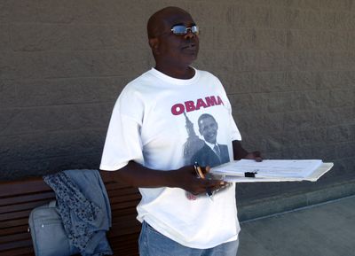 A man stands outside Target on Sprague Avenue in Spokane Valley May 21 collecting signatures for a petition to disincorporate the city. (J. BART RAYNIAK / The Spokesman-Review)