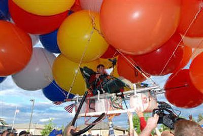 Kent Couch lifts off from his gas station in Bend, Ore., in his lawn chair rigged with more than 150 giant party balloons on Saturday. Associated Press
 (Associated Press / The Spokesman-Review)