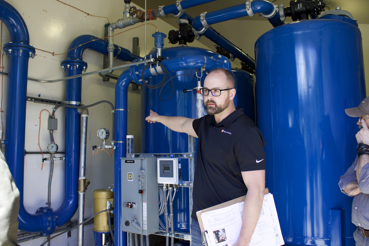 Tyler Larson, associate engineer for Haddocks, spoke Thursday afternoon about Hunters’ new water treatment system. The Hunters Water District is finishing a $1 million water treatment project that will help significantly reduce high levels of arsenic and manganese in the town’s water.  (Monica Carrillo-Casas)