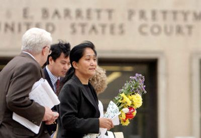 
Wenyi Wang, 47, the woman accused of heckling Chinese President Hu Jintao during a ceremony Thursday at the White House, walks outside of court in Washington on Friday
 (Associated Press / The Spokesman-Review)