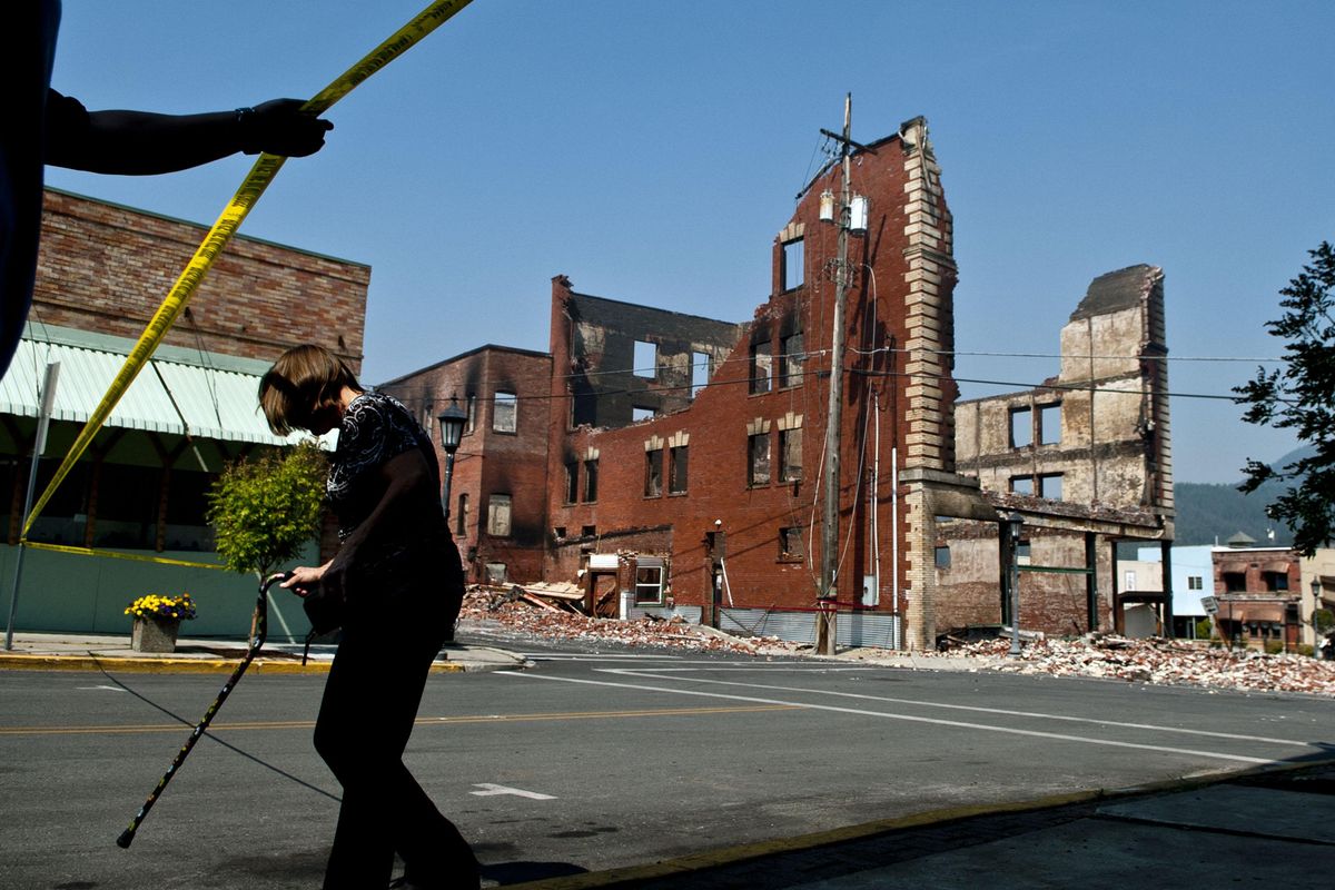Kellogg residents walk along Main Street to view what is left of an historic McConnell hotel on Thursday, Aug. 31, 2017. (Kathy Plonka / The Spokesman-Review)