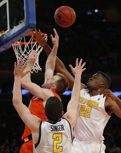 California’s Sam Singer and Kingsley Okoroh, right, defend as Syracuse guard Trevor Cooney attempts a layup. (Associated Press)