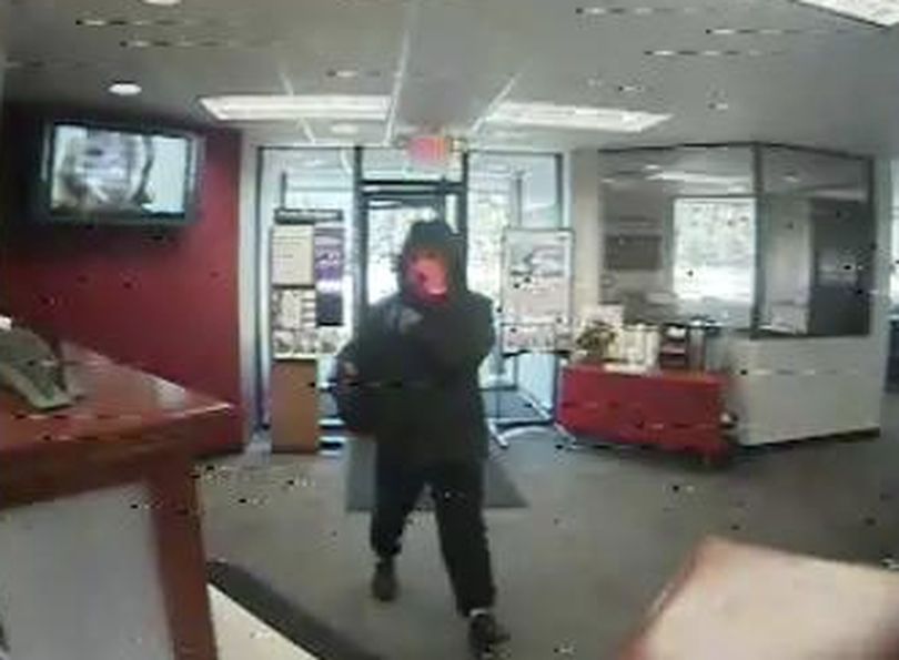 A gunman in a large parka and an orange ski mask robbed a bank in Rathdrum Thursday.
Surveillance photos show the man entering the Wells Fargo,16234 North Highway 41 , at 11:37 a.m. (Rathdrum Police Department)