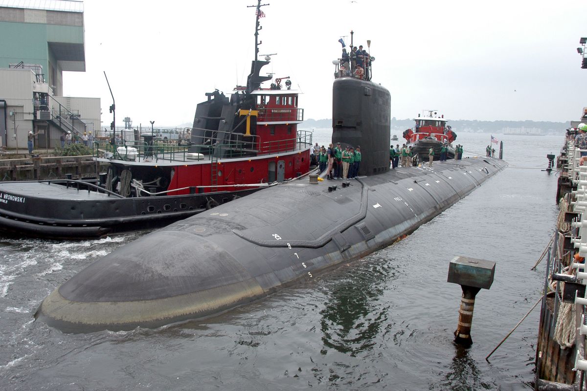 FILE - In this Friday, July 30, 2004 file photo, the U.S.S. Virginia returns to the Electric Boat Shipyard in Groton Conn., after its first sea trials. A Navy nuclear engineer with access to military secrets has been charged with trying to pass information about the design of American nuclear-powered submarines to someone he thought was a representative of a foreign government but who turned out to be an undercover FBI agent, the Justice Department said Sunday, Oct. 10, 2021. (Jack Sauer)