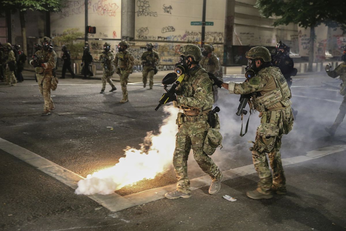 Police respond to protesters during a demonstration, Friday, July 17, 2020 in Portland, Ore. Militarized federal agents deployed by the president to Portland, fired tear gas against protesters again overnight as the city’s mayor demanded that the agents be removed and as the state’s attorney general vowed to seek a restraining order against them.  (Dave Killen)