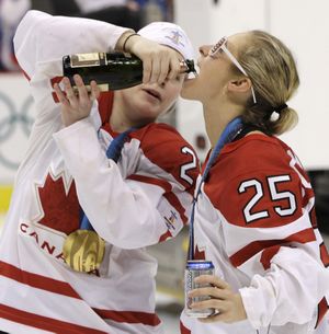 Canada Haley Irwin, left, and Tessa Bonhomme, right, celebrate after Canada beat USA 2-0 to win the women's gold medal ice hockey game at the Vancouver 2010 Olympics in Vancouver, British Columbia, Thursday, Feb. 25, 2010. (Chris O'meara / Associated Press)