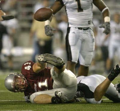
WSU tight end Jed Collins watches the ball fly away after a hard hit from Idaho safety Shiloh Keo.
 (Christopher Anderson / The Spokesman-Review)