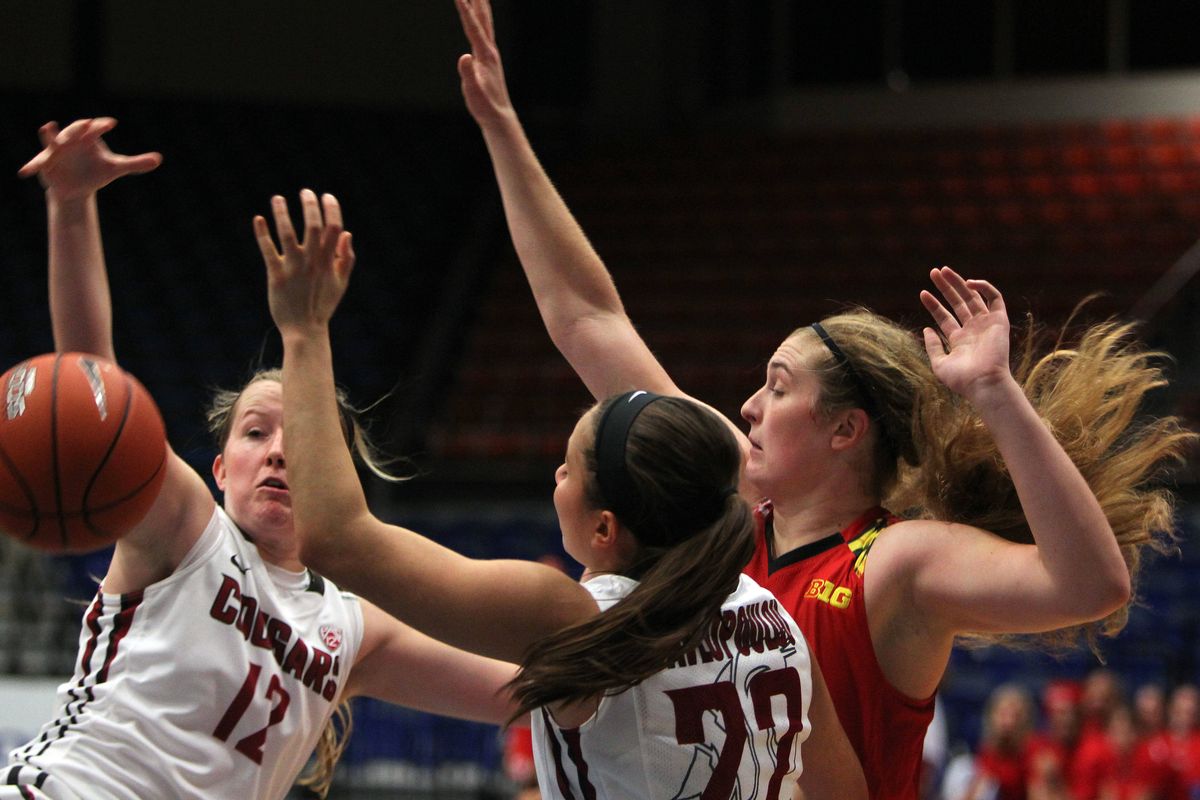 WSU’s Taylor Edmonson, left, and Pinelopi Pavlopoulou, center, battle for a rebound with Maryland’s Tierney Pfirman on Saturday. (Associated Press)