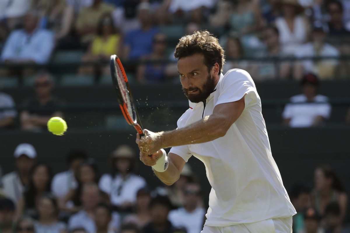 Ernests Gulbis of Latvia returns a ball to Alexander Zverev of Germany during their men’s singles match on the sixth day at the Wimbledon Tennis Championships in London, Saturday July 7, 2018. (Ben Curtis / Associated Press)