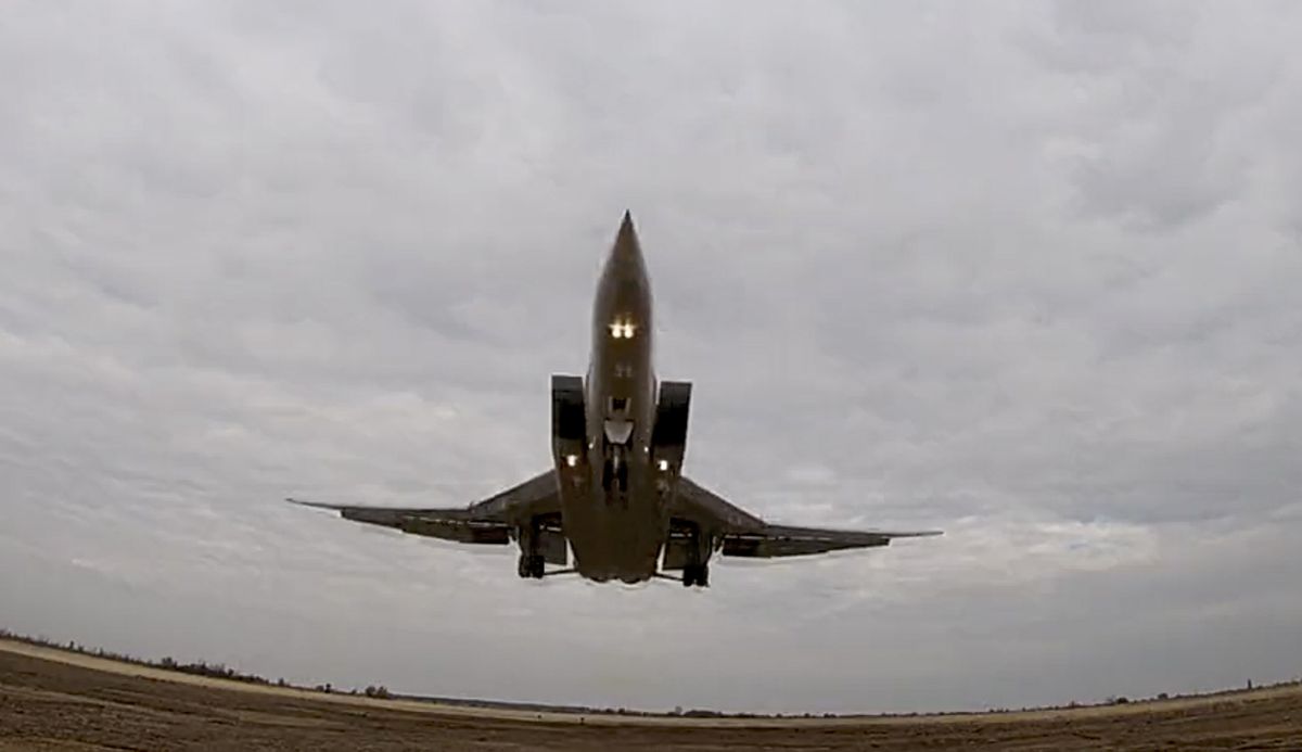 In this handout photo taken from video released by Russian Defense Ministry Press Service on Wednesday, Nov. 10, 2021, a long-range Tu-22M3 bomber of the Russian Aerospace Forces takes-off to patrol in the airspace of Belarus, Thursday, Nov. 11, 2021. Russia has sent two nuclear-capable strategic bombers on a training mission over Belarus in a show of Moscow